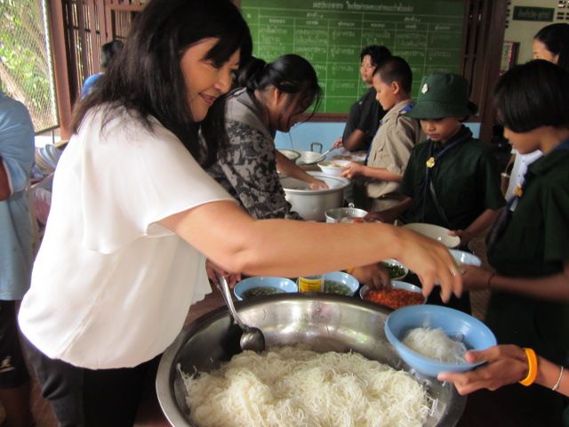 Vida Khow serving rice to children at a village school